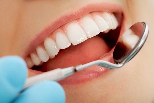 dentist checking on a patient's teeth