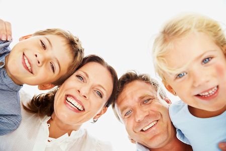 family of 4 smiling together
