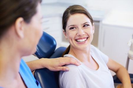 woman smiling after getting same-day dental crowns