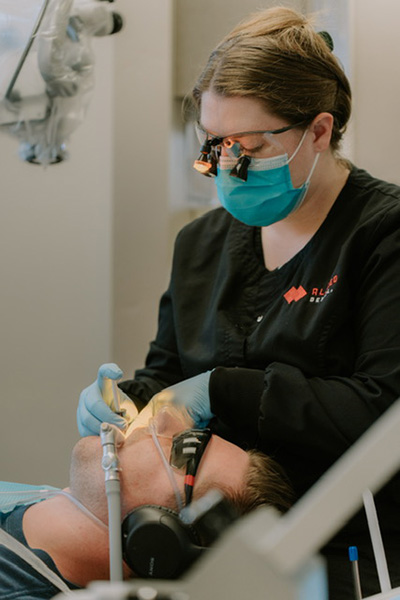 dentist performing oral surgery at Allred Dental